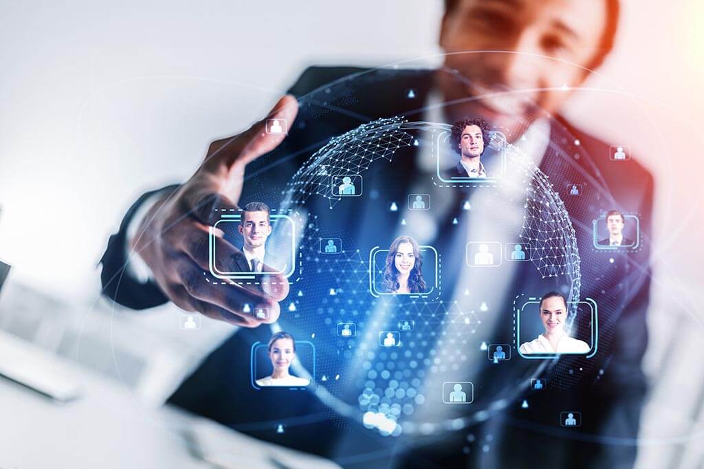 A businessman is holding up a hand with a group of people on it.